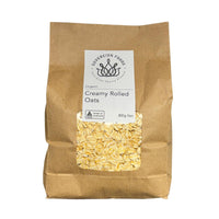 Bag of Australian grown organic rolled oats with a visible label on a white background