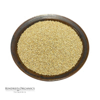 Brown bowl filled with Australian grown organic quinoa on a white background, branded 'Kindred Organics Tasmania'.